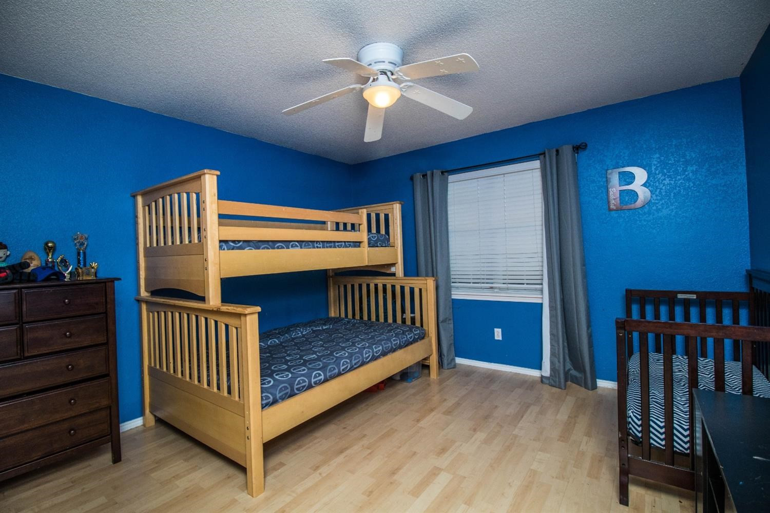 5821 89th Street Lubbock, TX 79424 - Photo 14 of 19 a bedroom with furniture and a chandelier