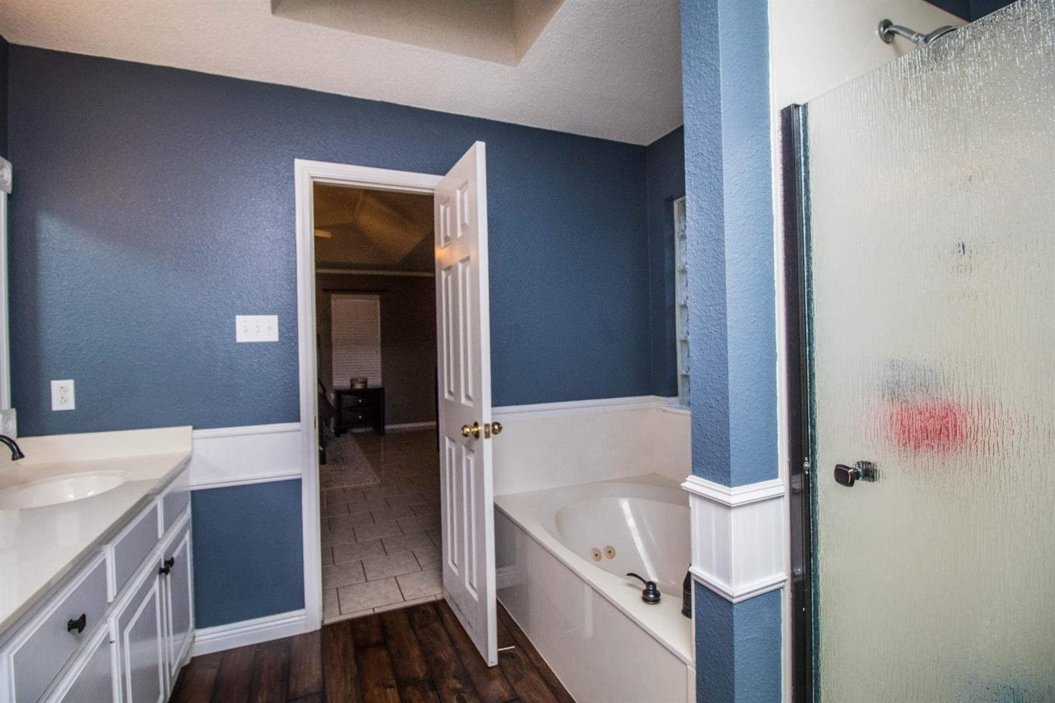 5821 89th Street Lubbock, TX 79424 - Photo 18 of 19 a bathroom with a bathtub and a sink