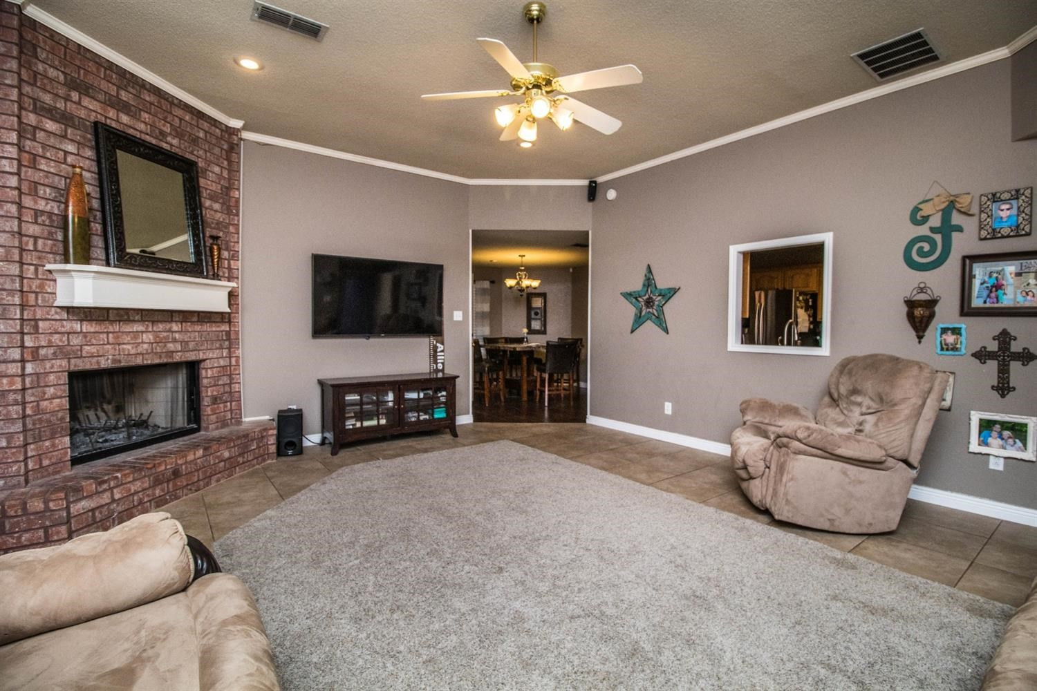5821 89th Street Lubbock, TX 79424 - Photo 2 of 19 a living room with furniture and a fireplace