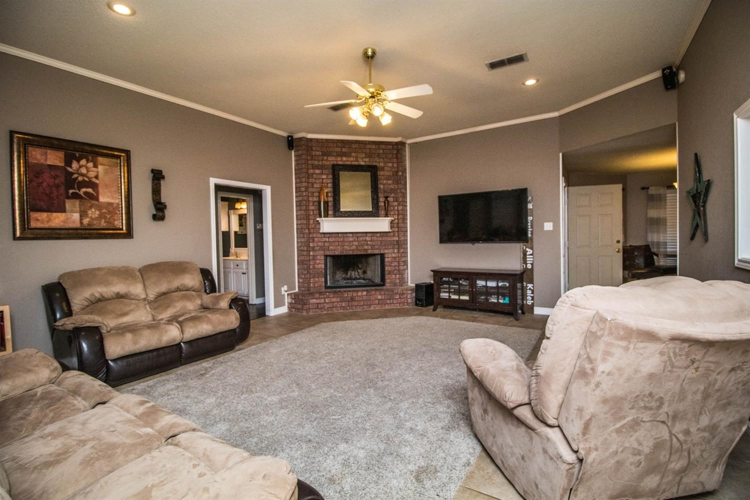 5821 89th Street Lubbock, TX 79424 - Photo 3 of 19 a living room with furniture and a flat screen tv