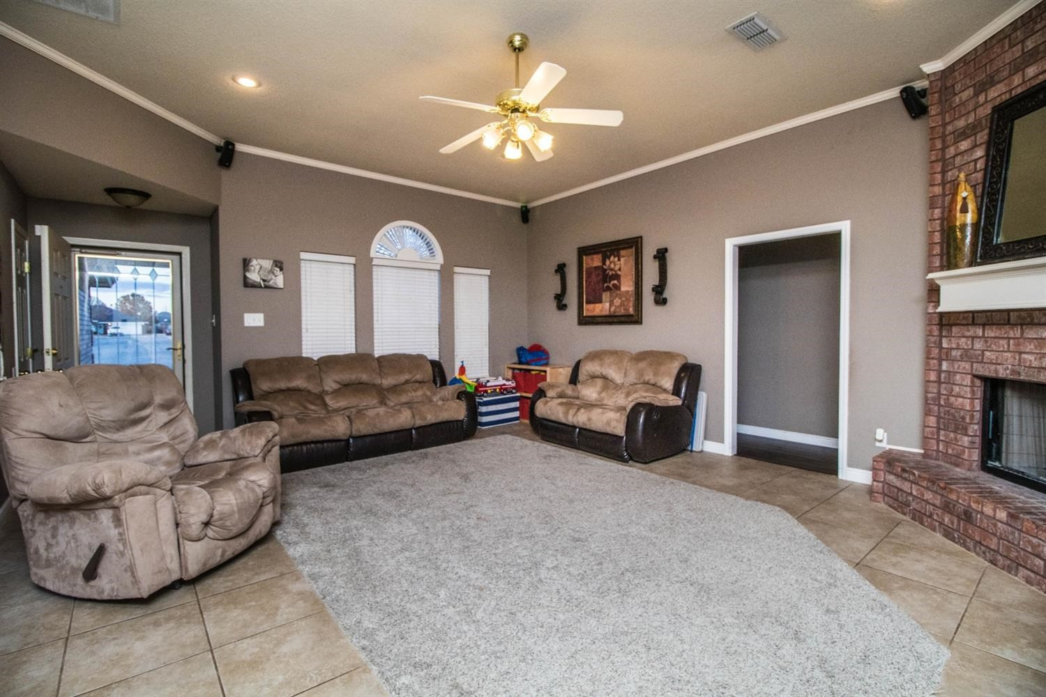 5821 89th Street Lubbock, TX 79424 - Photo 5 of 19 a living room with furniture and a fireplace