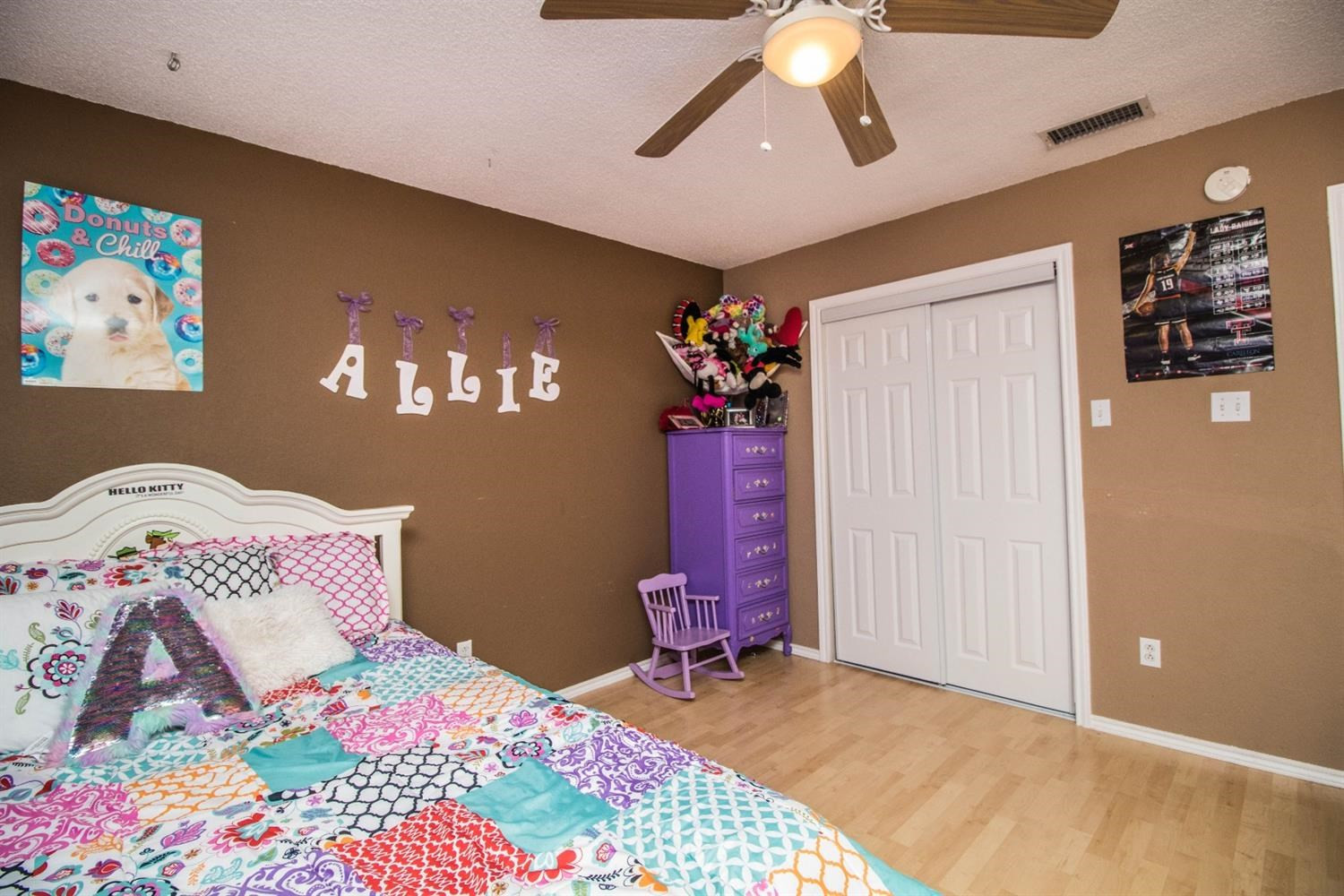 5821 89th Street Lubbock, TX 79424 - Photo 10 of 19 a bedroom with a bed and a chandelier