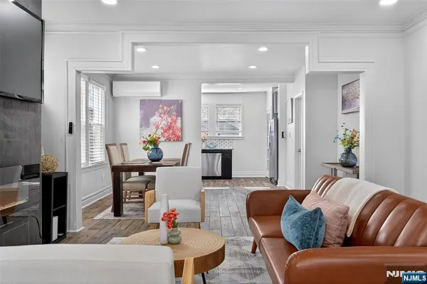 a living room with furniture and wooden floor