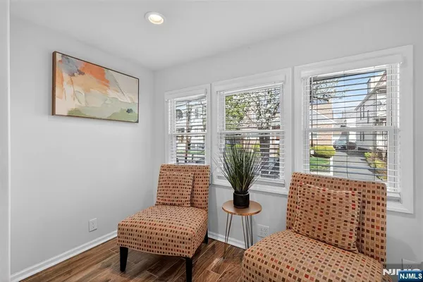 a living room with furniture and a floor to ceiling window