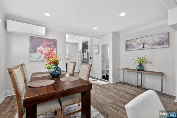 a view of a dining room with furniture and wooden floor