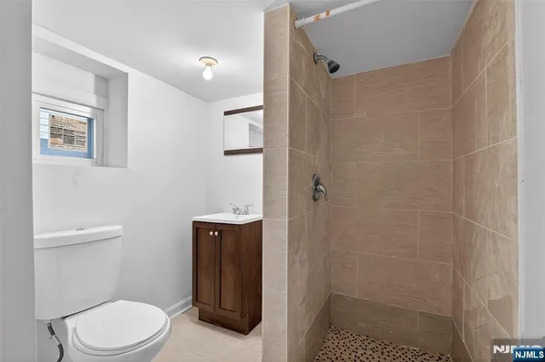 a white toilet sitting next to a bathroom sink