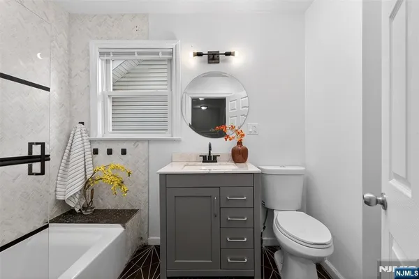 a bathroom with a sink toilet and mirror