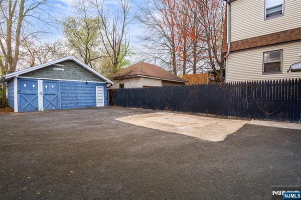 a brick house with a large tree in front of it