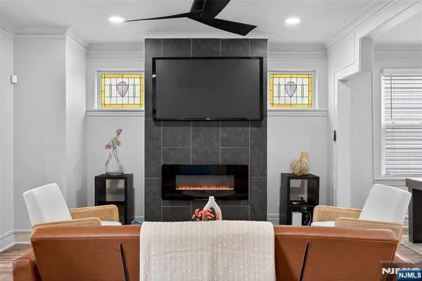 a living room with furniture a fireplace and a flat screen tv