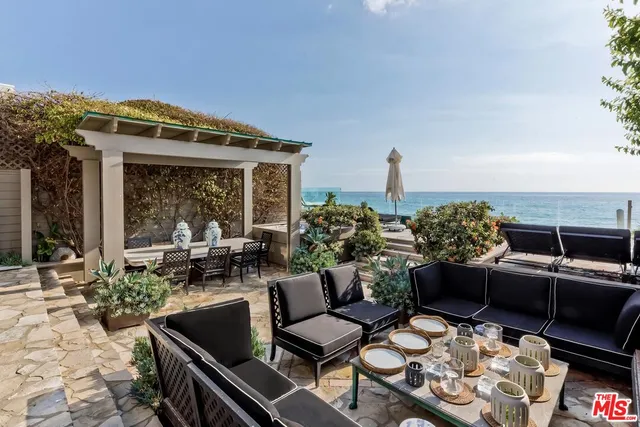 a outdoor living space with furniture and a fireplace