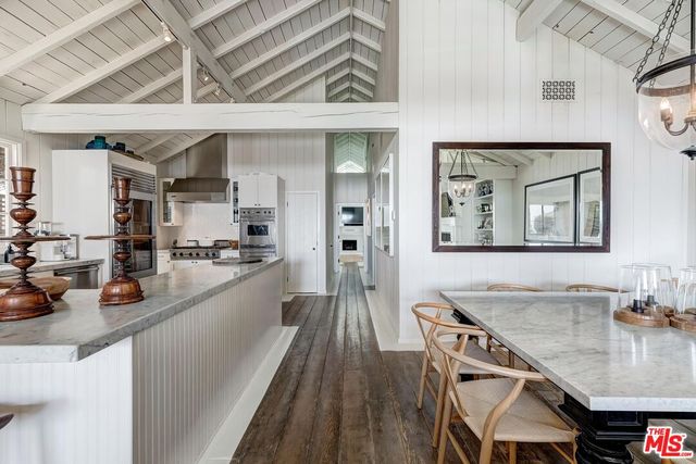 a large kitchen with a table and chairs
