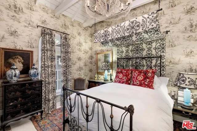 a bedroom with a bed and a fireplace