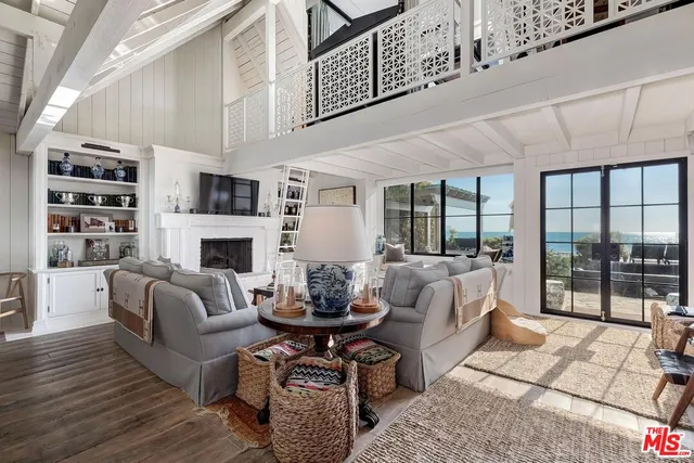 a living room with furniture fireplace and a table