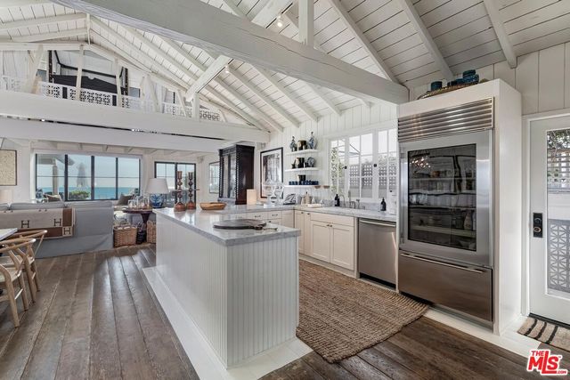 a kitchen with sink cabinets and stove top oven