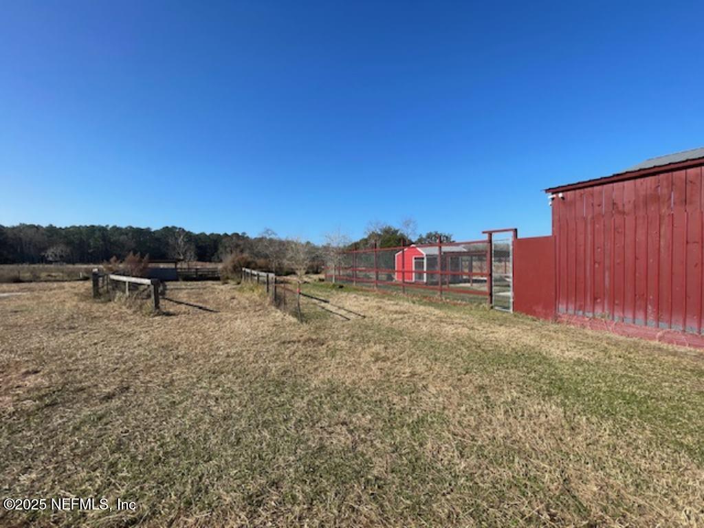 14014 Lem Turner Road Jacksonville, FL 32218 - Photo 11 of 25 a backyard of a house with table and chairs