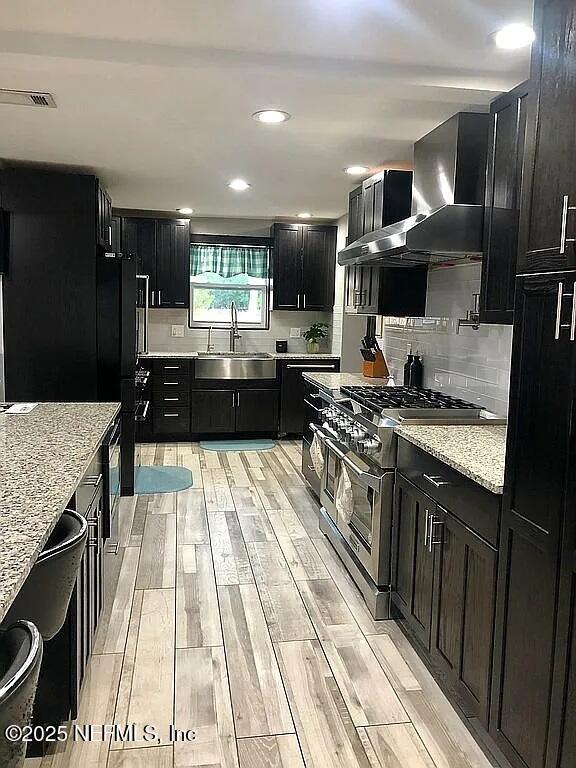 14014 Lem Turner Road Jacksonville, FL 32218 - Photo 13 of 25 a kitchen with stainless steel appliances kitchen island granite countertop a stove and a sink