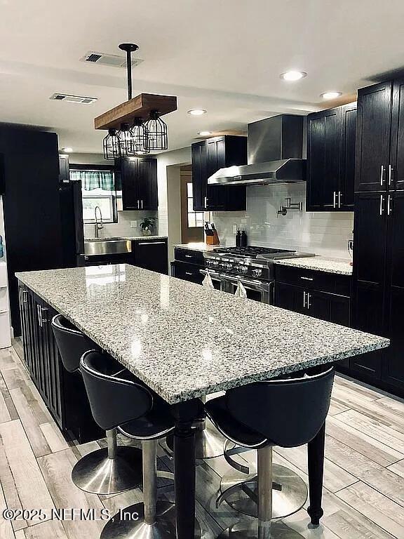 14014 Lem Turner Road Jacksonville, FL 32218 - Photo 14 of 25 a kitchen with stainless steel appliances kitchen island granite countertop a table chairs sink and cabinets