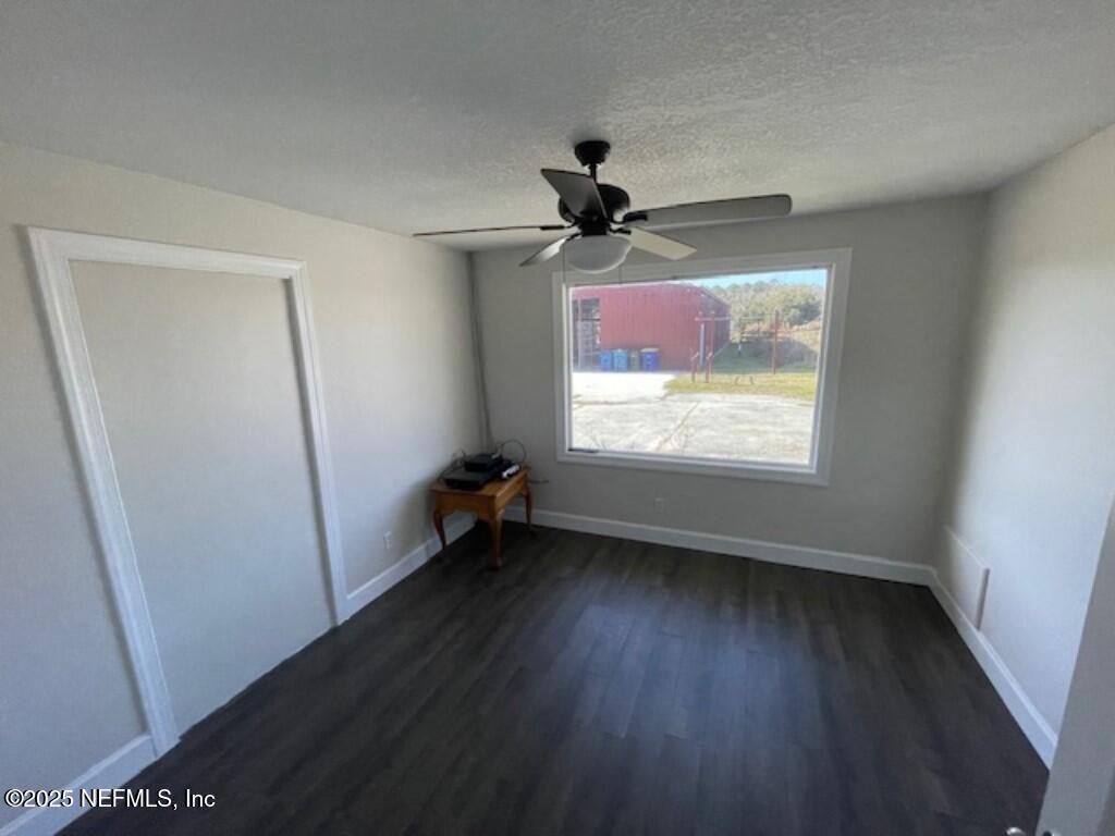 14014 Lem Turner Road Jacksonville, FL 32218 - Photo 18 of 25 wooden floor in an empty room with a window