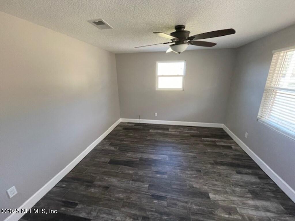 14014 Lem Turner Road Jacksonville, FL 32218 - Photo 19 of 25 wooden floor in an empty room with a window
