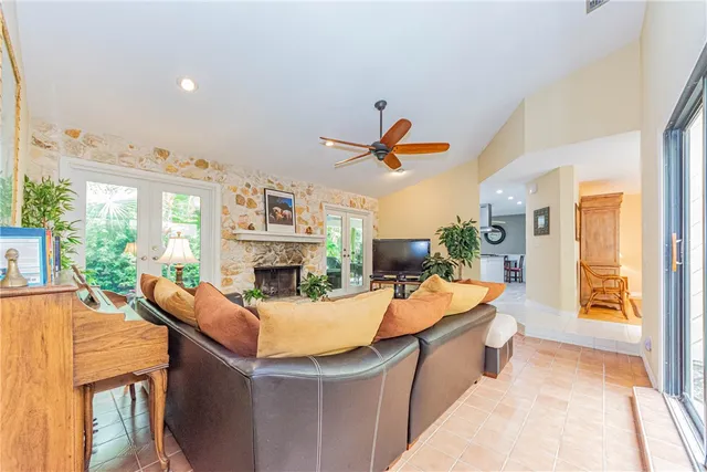 a living room with fireplace furniture and a large window