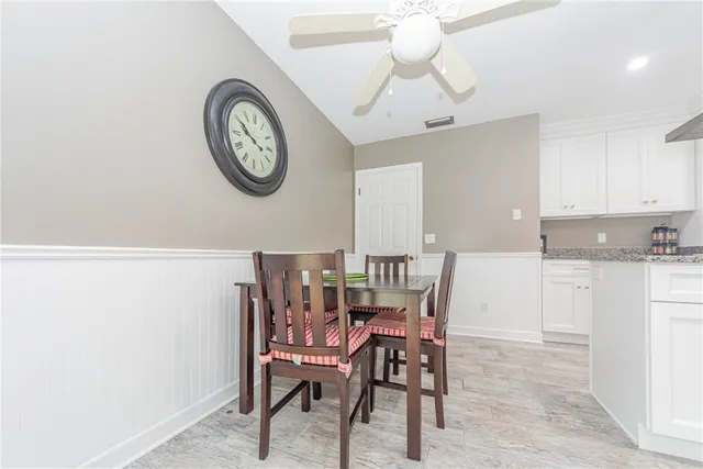 a view of a dining area with furniture and a clock