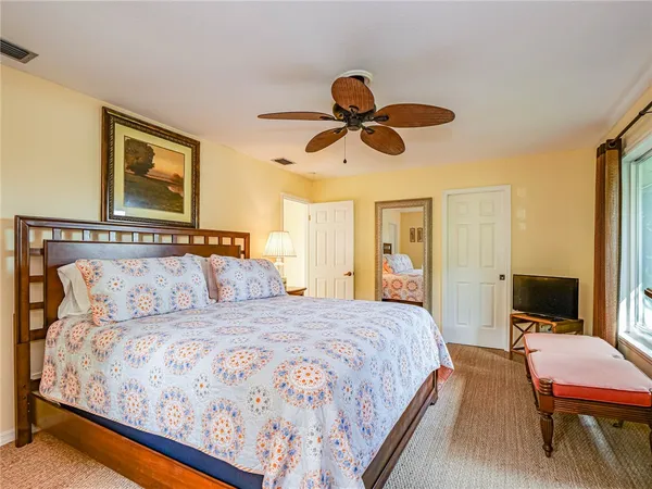 a bedroom with a large bed and a chandelier