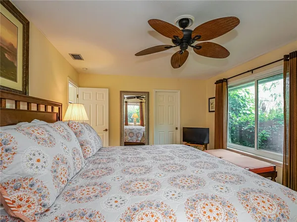 a bedroom with a bed and a large window