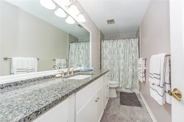 a bathroom with double vanity and a shower