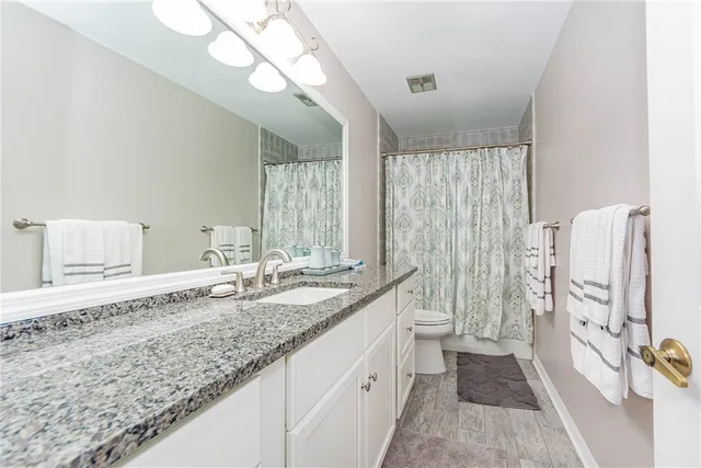 a bathroom with double vanity and a shower
