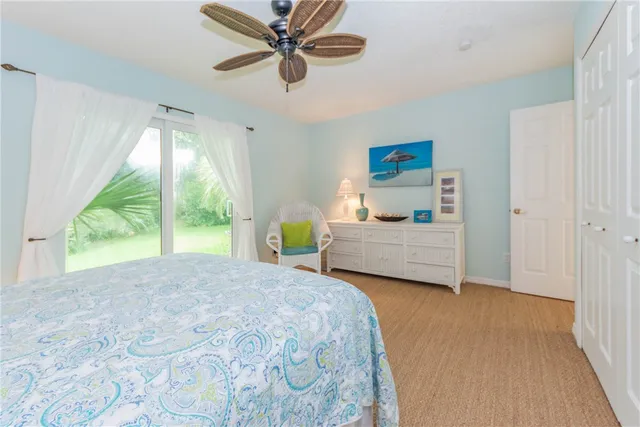 a bedroom with a bed window and a ceiling fan