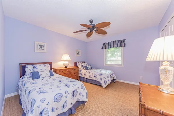 a bedroom with two beds and a chandelier
