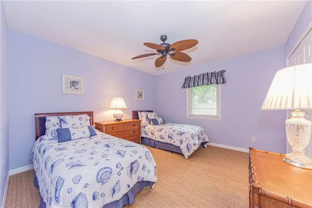 a bedroom with two beds and a chandelier