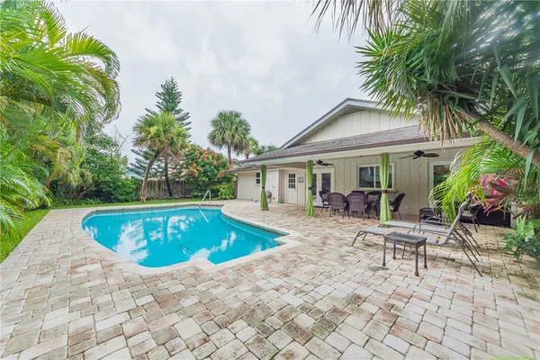 a view of a house with swimming pool and sitting area