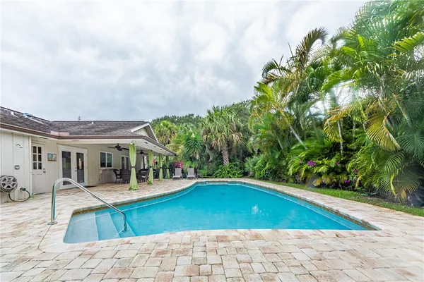 a swimming pool with outdoor seating and yard