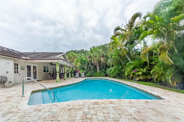 a swimming pool with outdoor seating and yard