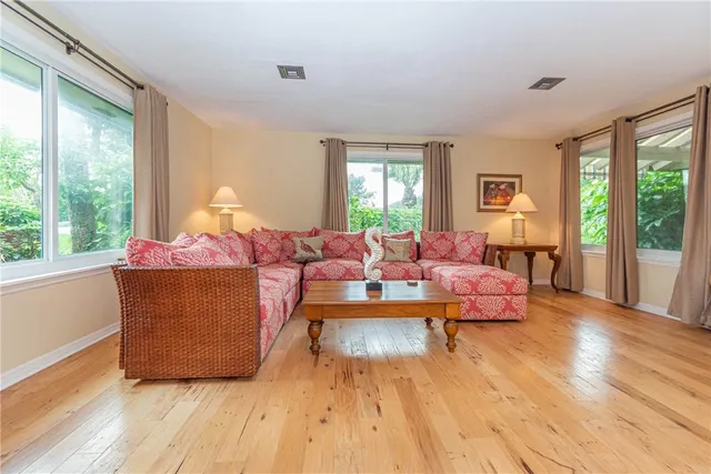a living room with furniture and large windows