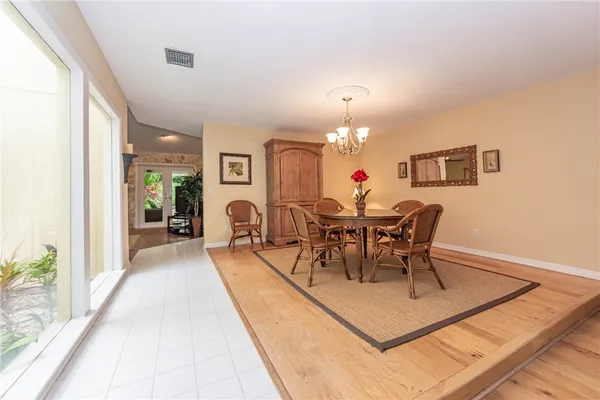 a view of a dining room with furniture and chandelier
