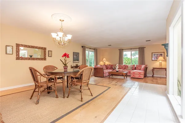 a view of a dining room with furniture and chandelier