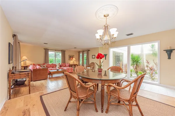 a view of a dining room with furniture wooden floor and chandelier