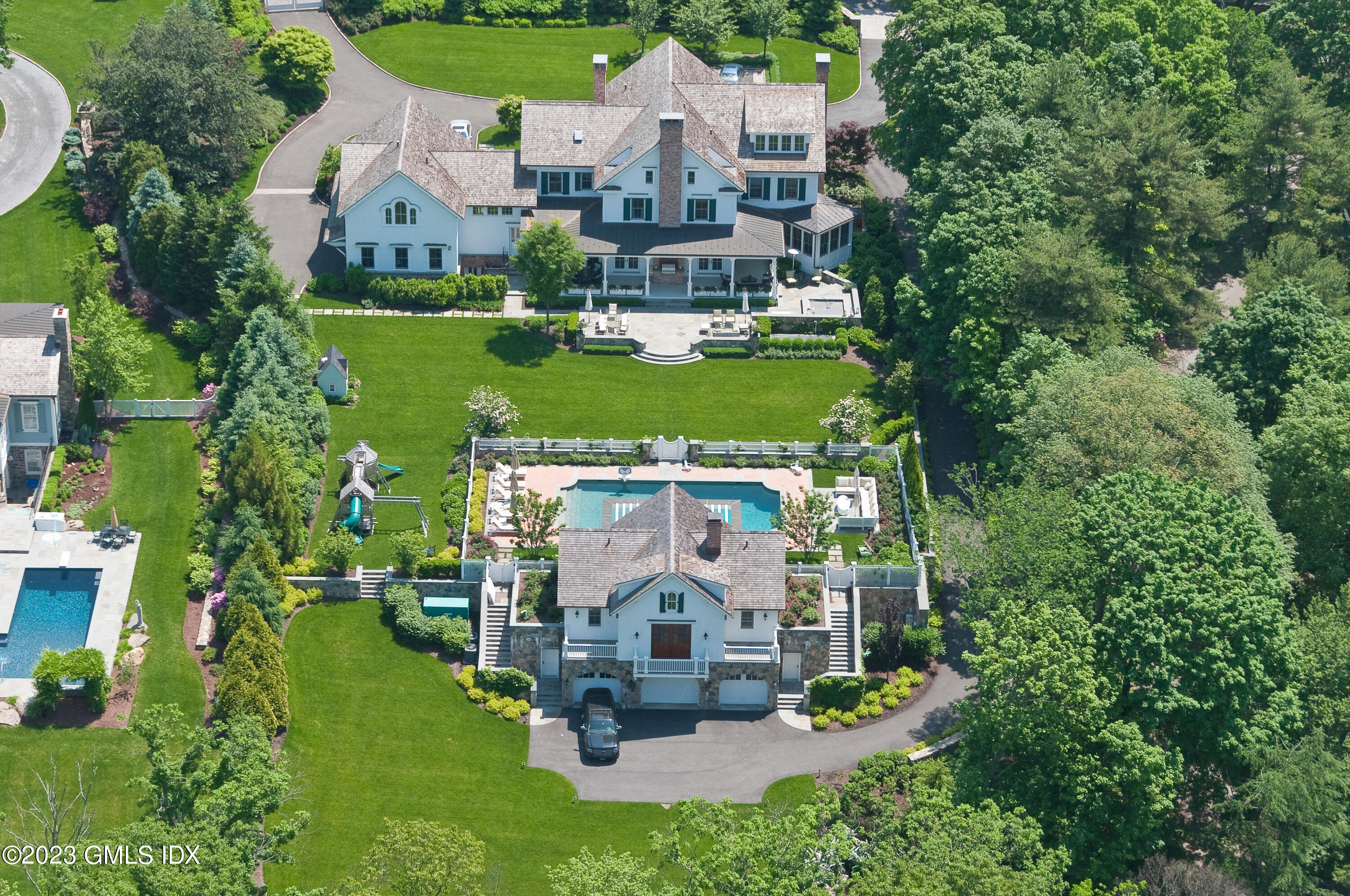 76 Doubling Road Greenwich, CT 06830 - Photo 1 of 1 an aerial view of a house with a garden and trees