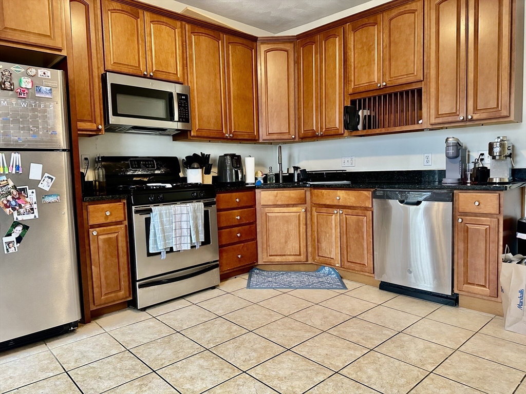 12-14 Marcella Street, Unit 2 Cambridge, MA 02141 - Photo 1 of 23 a kitchen with stainless steel appliances granite countertop a stove a sink and a microwave