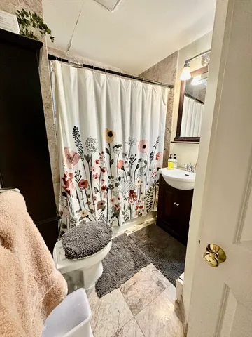 a bathroom with a bathtub sink and mirror