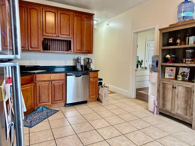 a kitchen with stainless steel appliances a refrigerator and cabinets