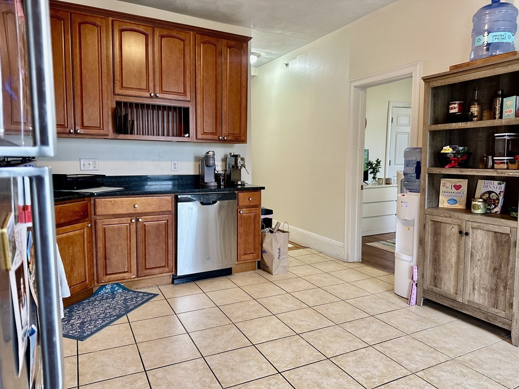 12-14 Marcella Street, Unit 2 Cambridge, MA 02141 - Photo 12 of 23 a kitchen with stainless steel appliances a refrigerator and cabinets