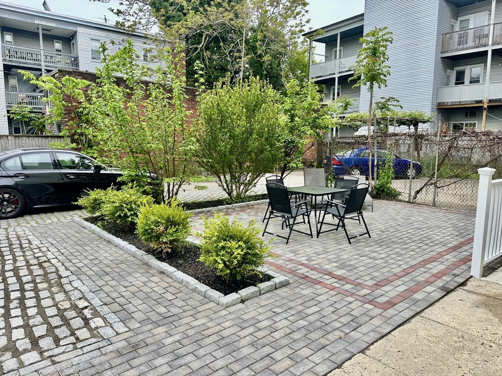 12-14 Marcella Street, Unit 2 Cambridge, MA 02141 - Photo 14 of 23 a view of a patio with table and chairs and potted plants