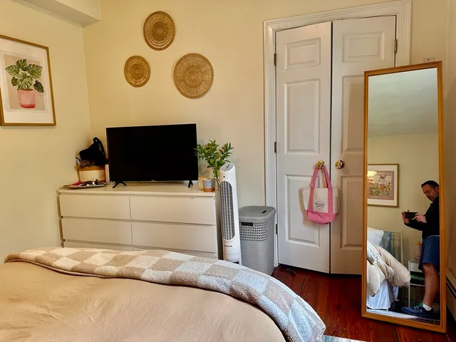 a bedroom with a bed and a television