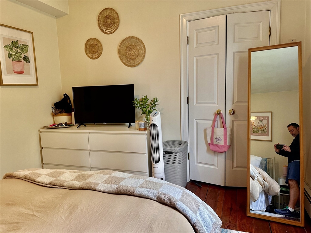 12-14 Marcella Street, Unit 2 Cambridge, MA 02141 - Photo 18 of 23 a bedroom with a bed and a television