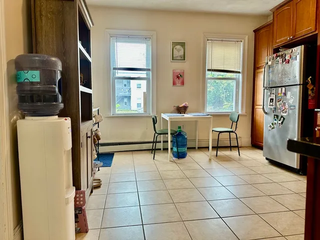 a living room with furniture a window and a flat screen tv