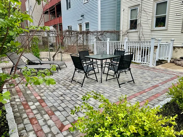 a view of a chairs and table in backyard of the house