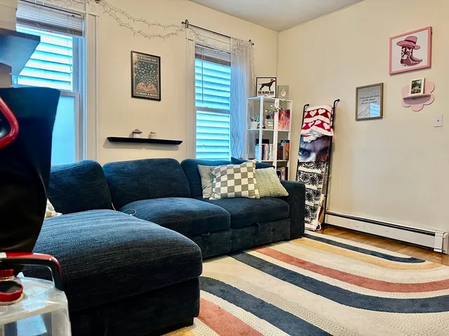 a living room with furniture flowerpot and a window